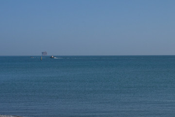 fishing boat in sea,blue,sky,calm, fishing,water,horizon,