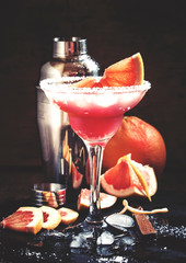 Alcoholic cocktail Greyhound, with vodka, liqueur, grapefruit juice and ice, black background, selective focus