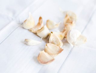 Fototapeta na wymiar Garlic Cloves Peels White Tablecloth