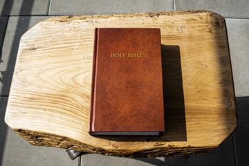 Flat lay Holy Bible on wooden background. Baselland, Switzerland 12.05.2019