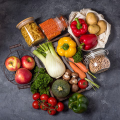 Vegetables, fruits and food in reusable cotton bag and glass jars, eco-friendly shopping on farmer's market, zero waste