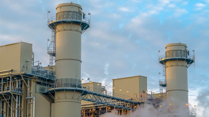 Panorama Cloudy blue sky viewed behind the towers and buildings of a Power Plant