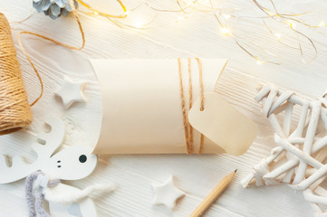 mockup Christmas kraft gift boxes with tag on wooden background. Top view for greeting card