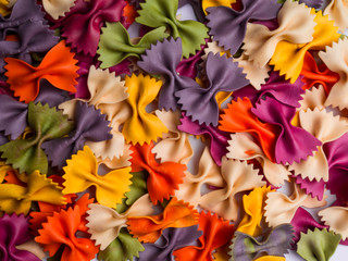 colorful Italian pasta background. Various colors of bow tie farfalle pasta. Top view.