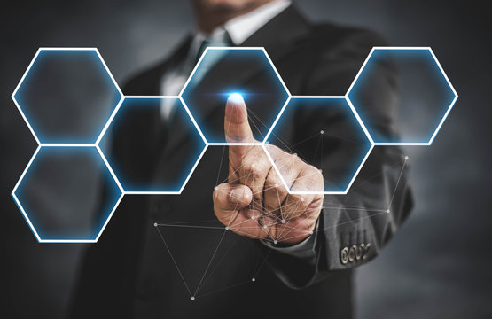 businessman touching virtual screen on hexagon