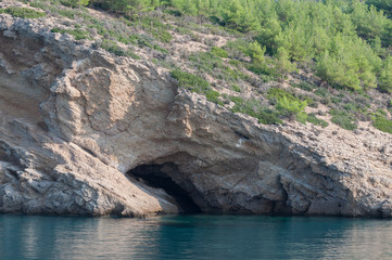 small hidden tunnel in the mountain's wall seen from the boat