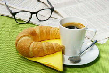  Small quick breakfast with croissant and newspaper, copy space