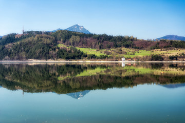 Fototapeta na wymiar Reflection of hill Choč in lake Liptovska Mara, Slovakia