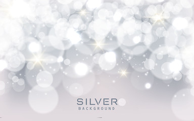 Silver abstract bokeh background sparkling lights effect. Blured circle on gray background.