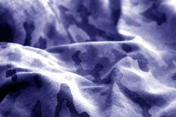 Old camouflage cloth with blur effect in blue tone. © pavelalexeev