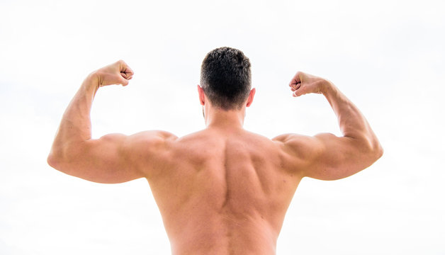 I am the best. Macho with naked back demonstrates his strength. muscular back man isolated on white. Sportsman celebrates victory. Sporty handome male training in gym. Athletic fitness competition