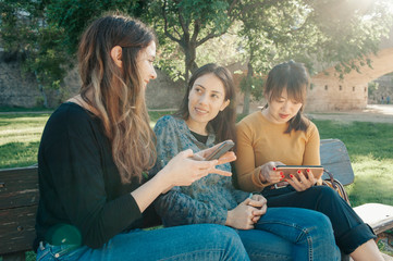Fototapeta premium three friends with their mobile phones