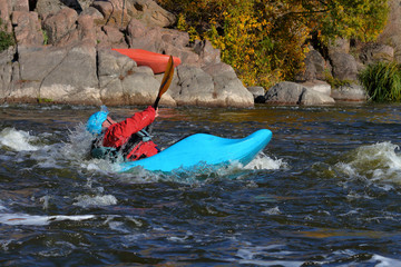 Whitewater kayaking on fast moving water of mountain river among the rapids, extreme water sport. Kayak freestyle on whitewater.