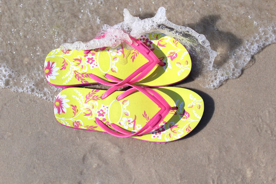 Colorful flip flops on the beach.  Summer time