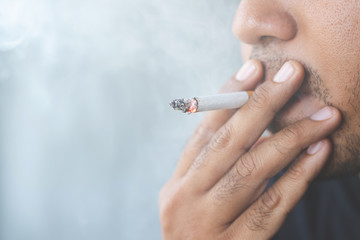 man smoking a cigarette. Cigarette smoke spread. 