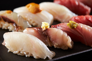 Japanese luxury assorted sushi on black background 