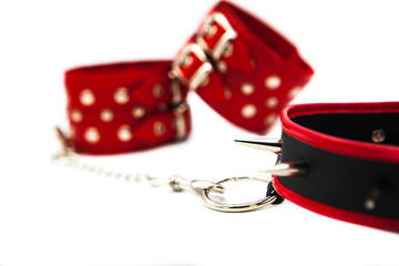 Leather handcuffs and collar with spikes isolated on white background. Sex toy for intimate...