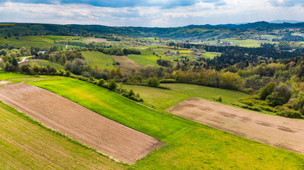 Farmlands and mountains in rural Poland seen from drone