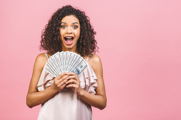 Rich girl! Money winner! Surprised beautiful african american woman in dress holding money and...