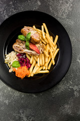 Chicken wraps with fries and salad, restaurant serving portion