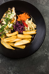 Grilled chicken breast with fries and salad, restaurant serving plate