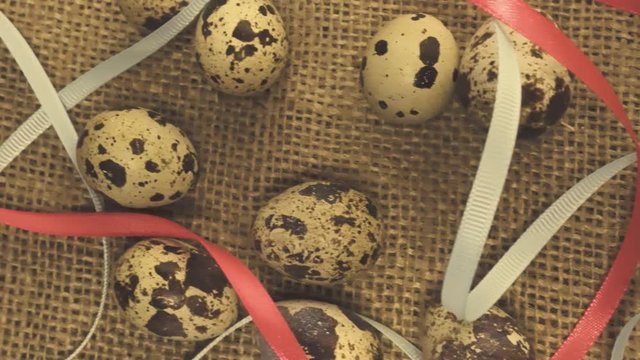 Easter eggs with a ribbon on a rag background with straw