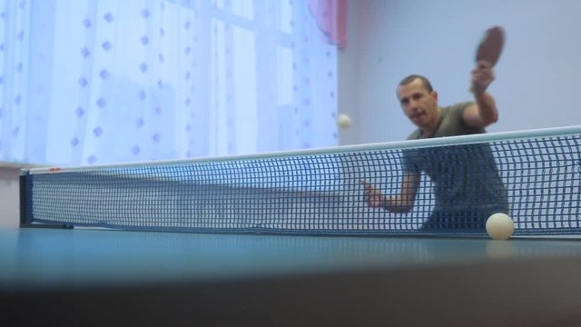 table tennis lifestyle backhand concept. slow motion video. blurred focus man playing training table tennis the sport active
