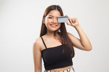 Young Asian woman with  blank card over her eye.