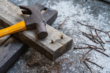 Hammer, rusty nail and wood for carpenter's job