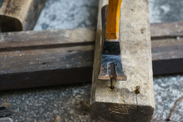 Hammer, rusty nail and wood for carpenter's job