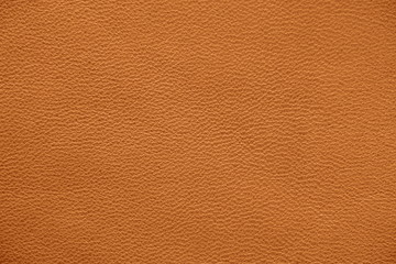 The texture of genuine leather. Impeccable and stylish background. Beautiful stylish background. Natural skin texture close up. Brown background.  The structure of the leather material brown shades.