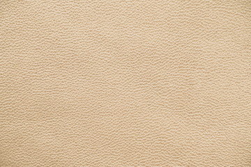 The texture of genuine leather.  Brown background.  The structure of the leather material brown shades.