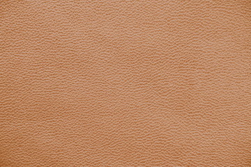 The texture of genuine leather.  Brown background.  The structure of the leather material brown shades.