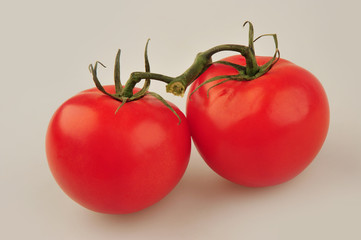 Fresh tomatoes isolated on the gray background