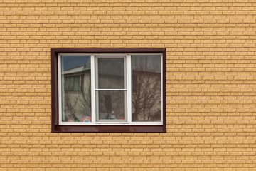 The window in the wall of the house of yellow brick