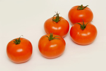 Fresh tomatoes isolated on the gray background