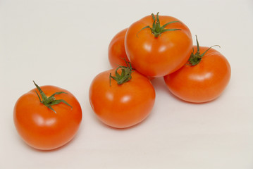 Fresh tomatoes isolated on the gray background