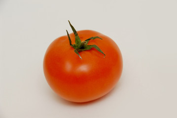 Fresh tomato isolated on the gray background
