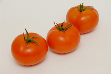 Fresh tomatoes isolated on the gray background