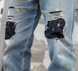 Old jeans on a construction worker's legs
