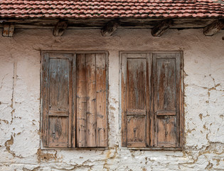 Old Style Brownish Wooden House of the Mud Windows