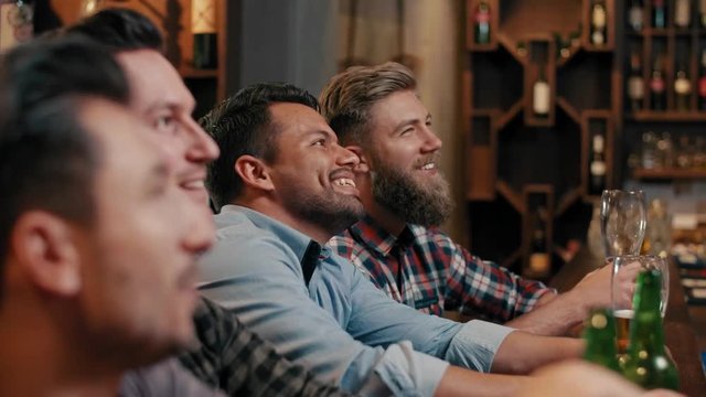 Male friends spending time together in the pub 