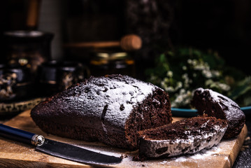 Pieces of chocolate cake on a wooden board. Powdered icing. Chocolate Brownie.