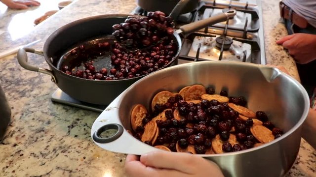 Front view Approaching. Putting some raisins in the pot. Women making Mole in Puebla Mexico. North America. Two people grinding some ingredients. Cooking Traditional recipe.