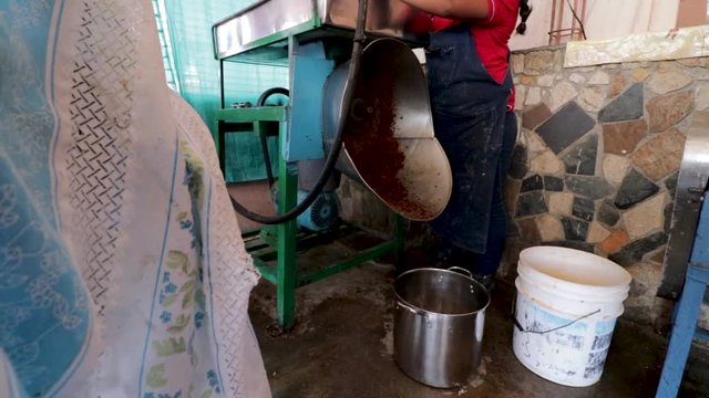Side view. Woman making Mole in Puebla Mexico. North America. Woman grinding some ingredients. Cooking Traditional recipe.