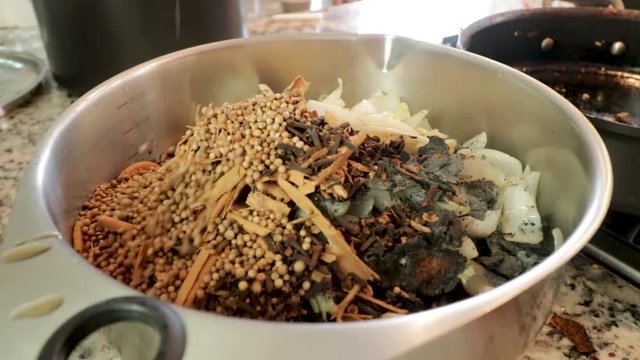 Front View. Pot with ingredients. Woman making Mole in Puebla Mexico. North America. Two people grinding some ingredients. Cooking Traditional recipe.