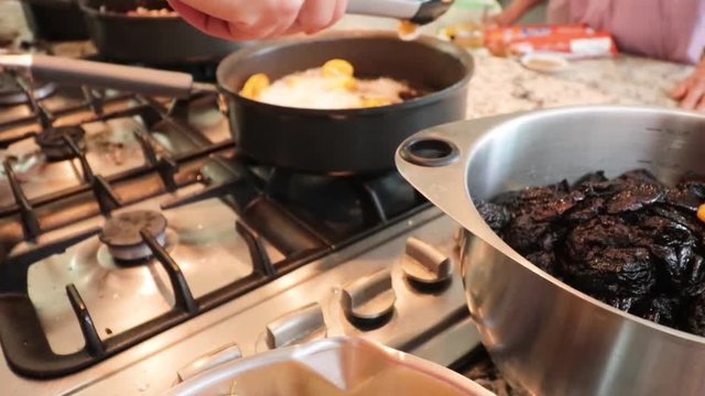 Top view. Cooking some bananas in the pot. Women making Mole in Puebla Mexico. North America. Two people grinding some ingredients. Cooking Traditional recipe.