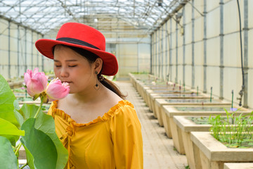 women smelling the flower lotus on Nursery lotus