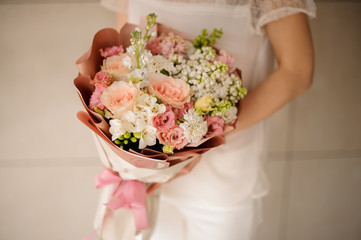 Close shot of beautiful bouquet in peach wrapping