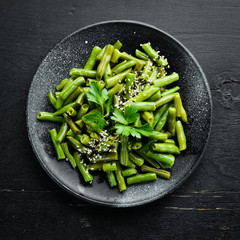Boiled Green Asparagus Bean. In a black plate. Top view. Free copy space.